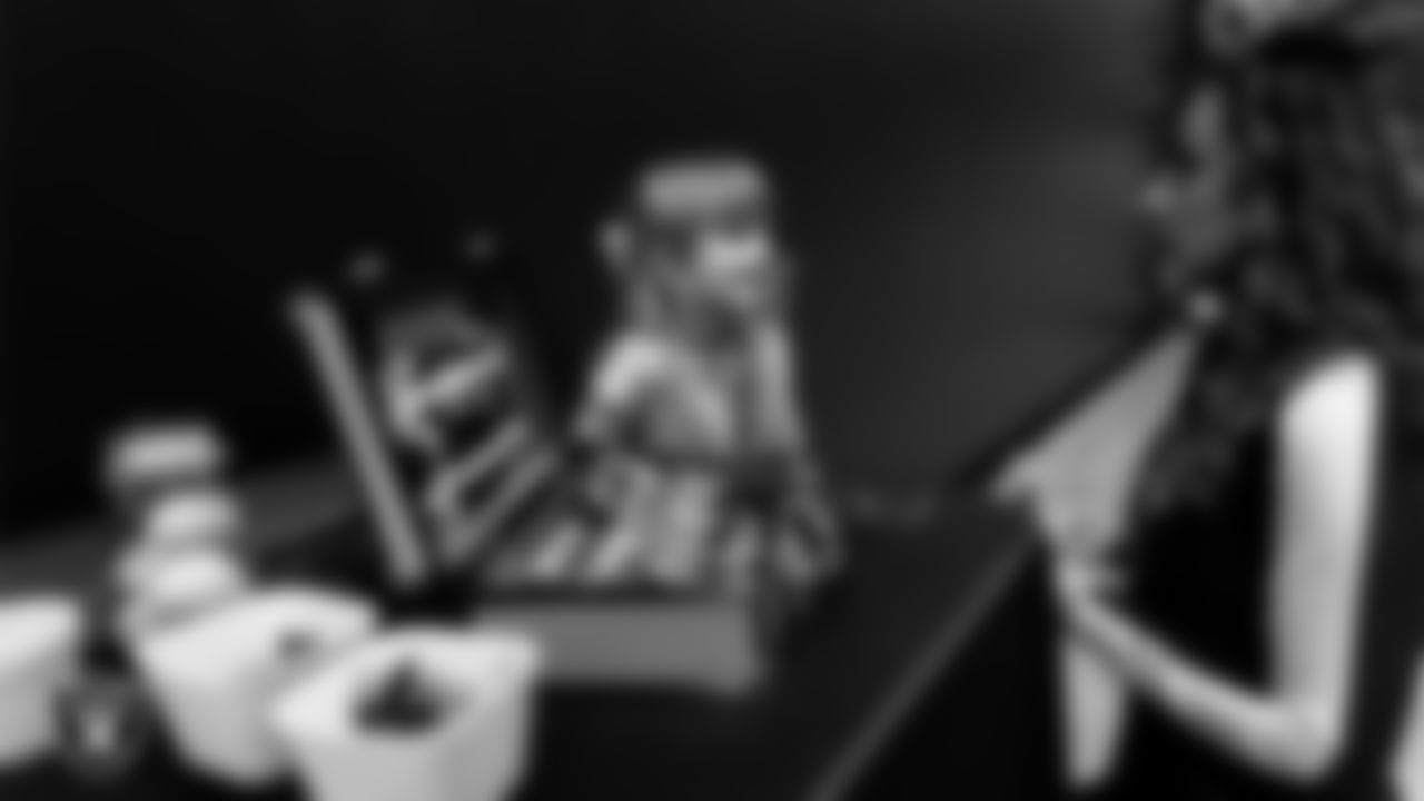 Raiderette Lexie does an attendee's makeup during the Valentine's Day Dance at The Studio.