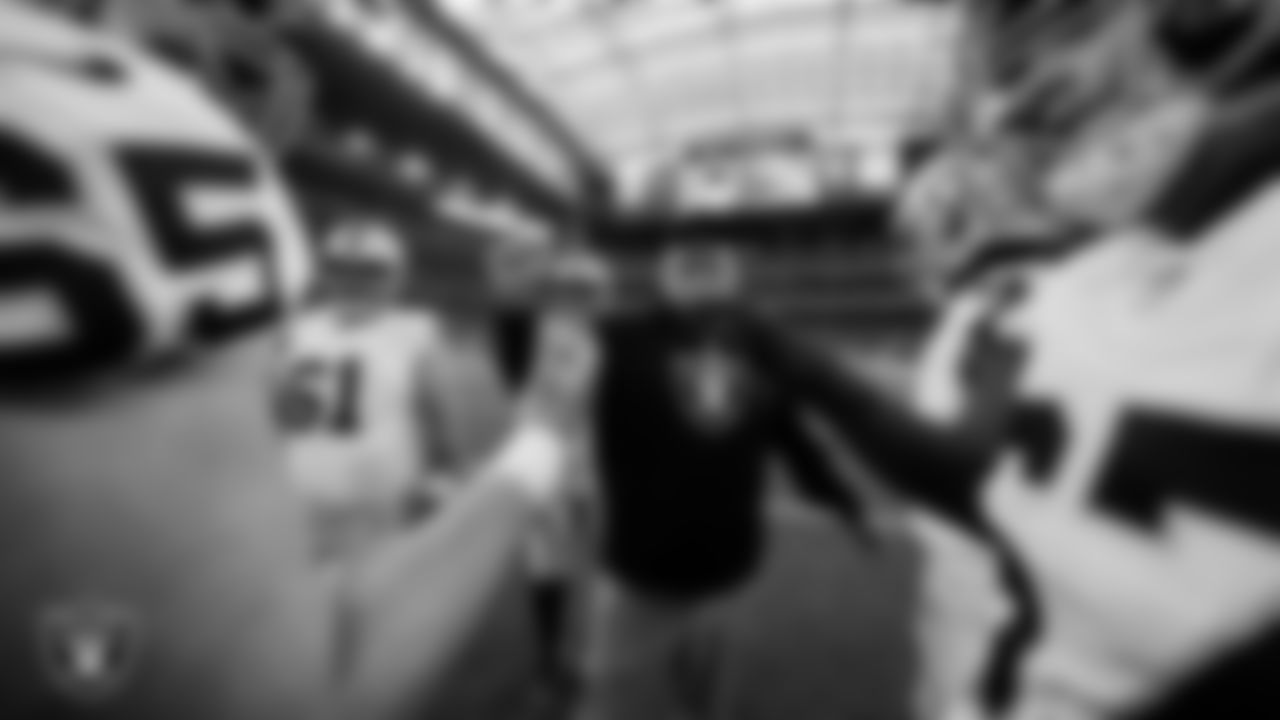 Las Vegas Raiders run game coordinator/offensive line coach Brennan Carroll and the offensive linemen huddle before the regular season away game against the Houston Texans at NRG Stadium.