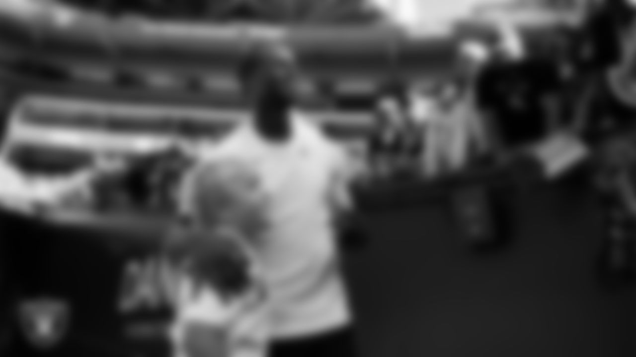Las Vegas Raiders quarterback Geno Smith (7) with a fan before the preseason away game against the Seattle Seahawks at Lumen Field.