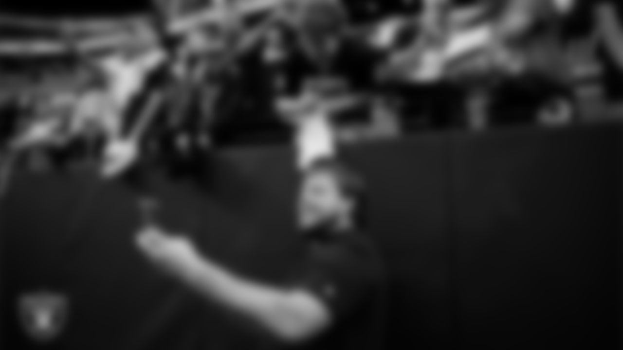 Las Vegas Raiders center Jackson Powers-Johnson (58) takes a selfie with fans before the preseason home game against the San Francisco 49ers at Allegiant Stadium.