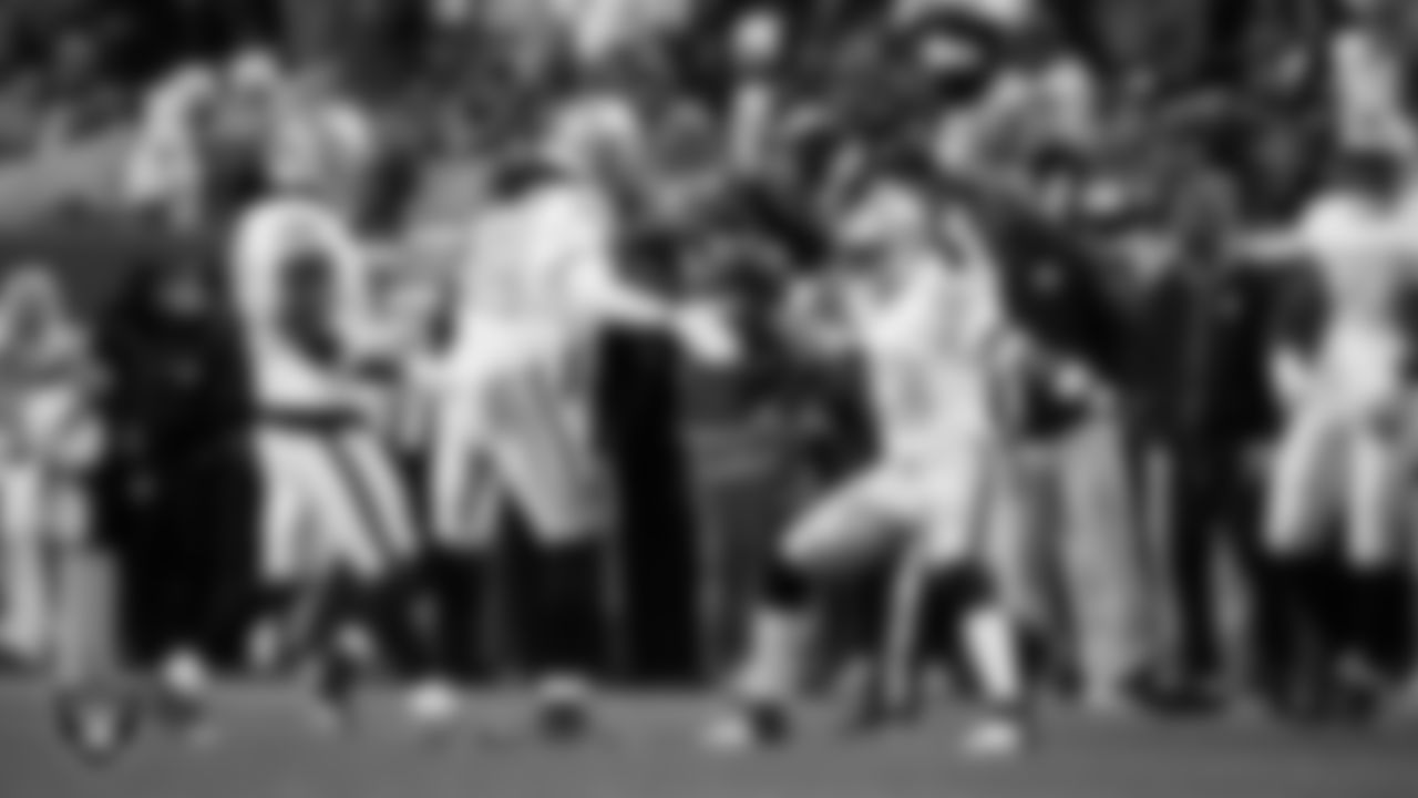 Las Vegas Raiders safety Lonnie Johnson Jr. (32) celebrates with linebacker Jamal Adams (33) after making a tackle during the regular season away game against the Denver Broncos at Empower Field at Mile High.