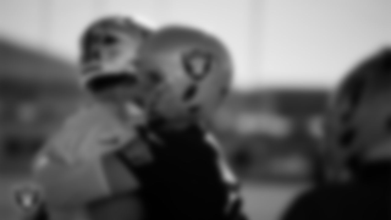 Las Vegas Raiders tackle Kolton Miller (74) and defensive end Maxx Crosby (98) during practice at Intermountain Health Performance Center.