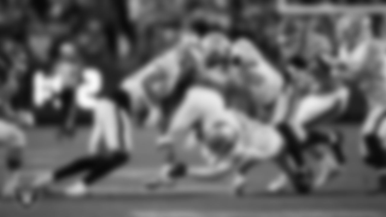 Las Vegas Raiders safety Isaiah Pola-Mao (20), long snapper Jacob Bobenmoyer (50) and linebacker Tommy Eichenberg (44) make a tackle during the regular season away game against the Denver Broncos at Empower Field at Mile High.