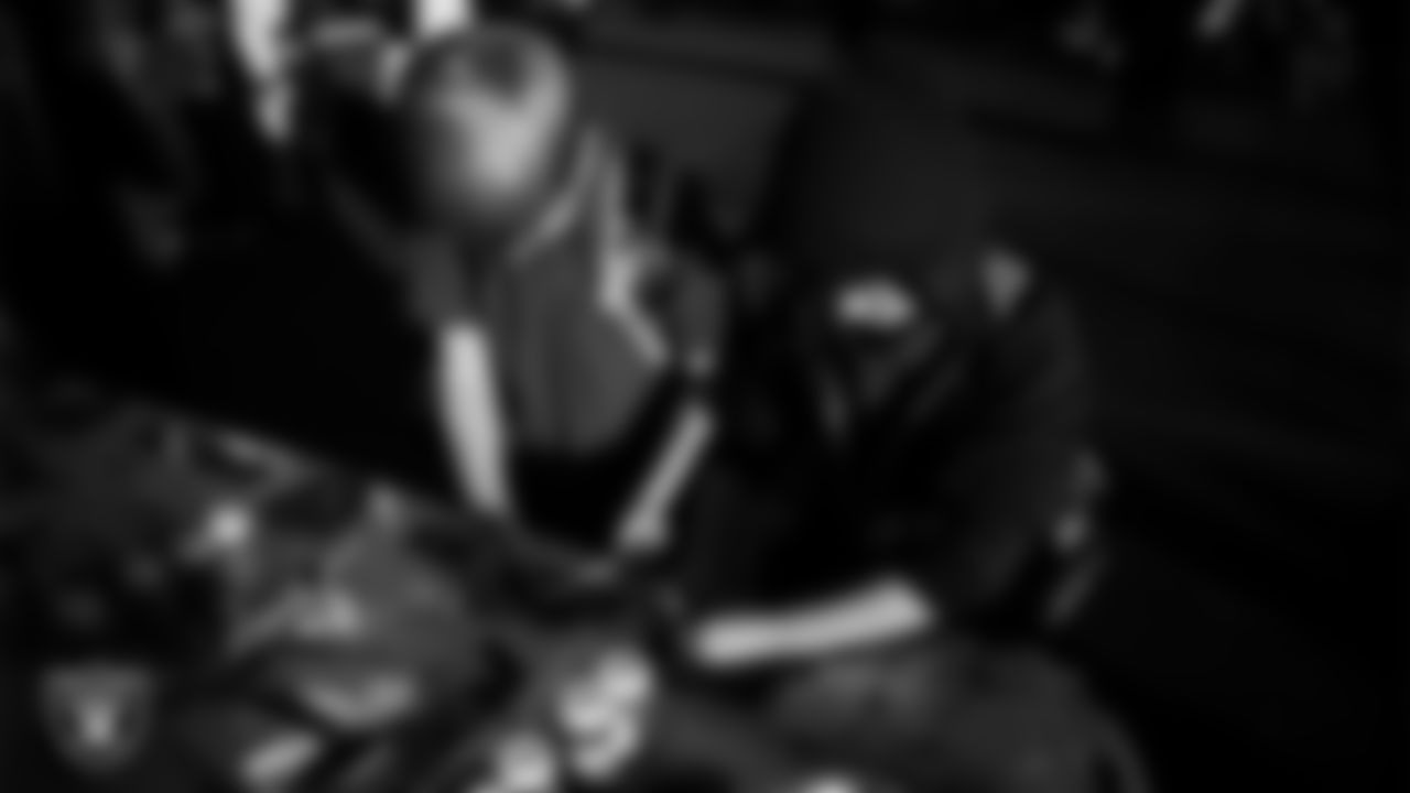 Children decorate cookies during the Raiders Holiday Salute at Nellis Air Force Base - Coral Academy.