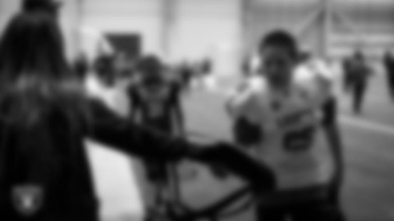 An athlete receives Las Vegas Raiders gear during an open practice at Intermountain Health Performance Center.