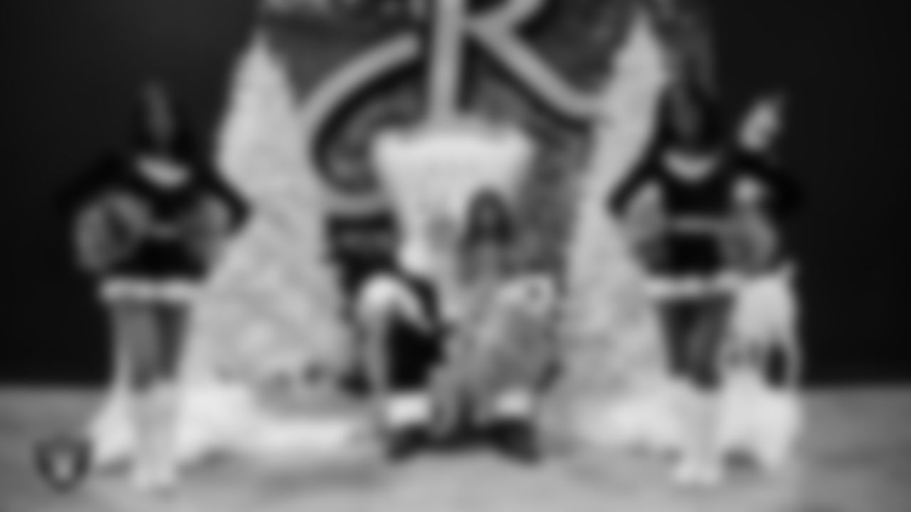 A Junior Raiderette poses for a photo with Santa during the Junior Raiderettes Banquet at The Studio.