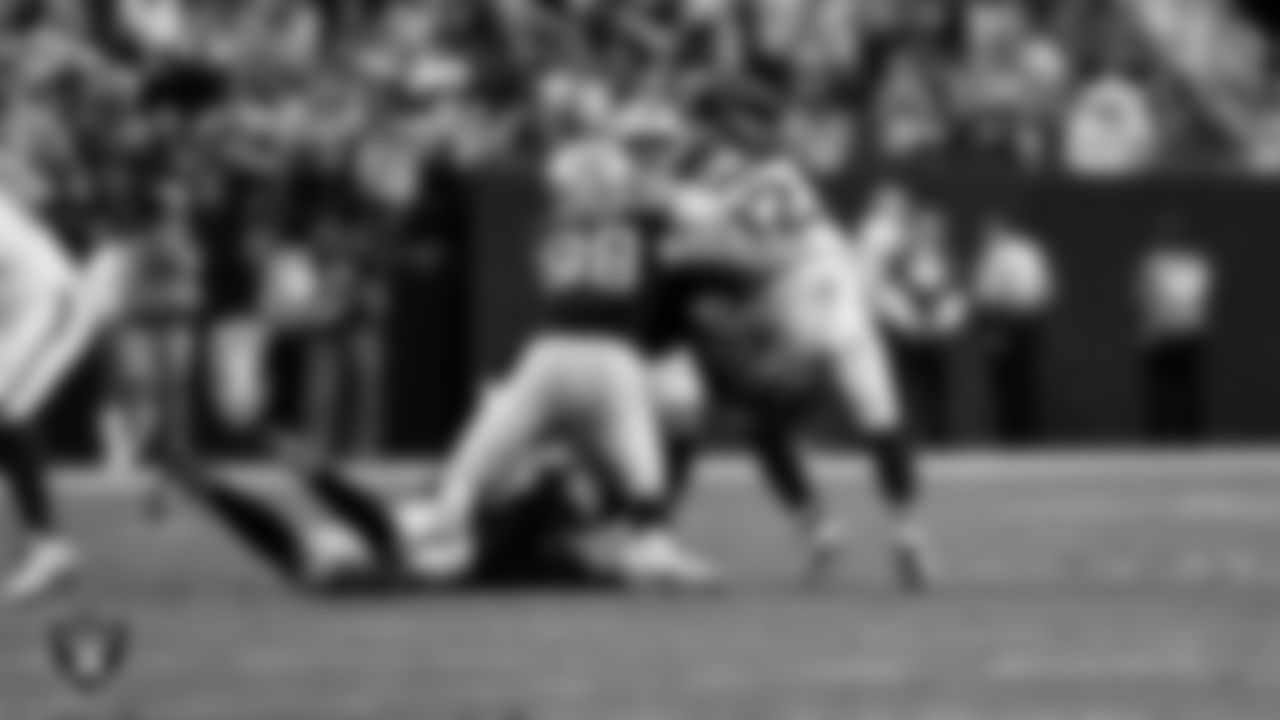 Las Vegas Raiders linebacker Elandon Roberts (52), defensive end Maxx Crosby (98) and linebacker Devin White (45) during the regular season home game against the Denver Broncos at Allegiant Stadium.