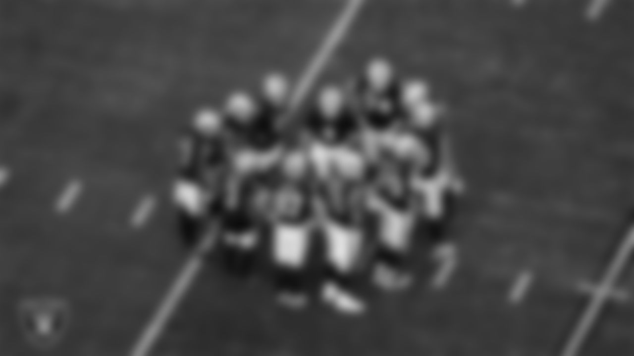 The Las Vegas Raiders huddle during the regular season home game against the New York Giants at Allegiant Stadium.