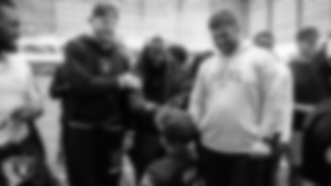 Cruz Avila from the Make-A-Wish Foundation meets Las Vegas Raiders defensive end Maxx Crosby (98), wide receiver Davante Adams (17) and offensive lineman Hroniss Grasu (65) during a visit to Intermountain Health Performance Center.