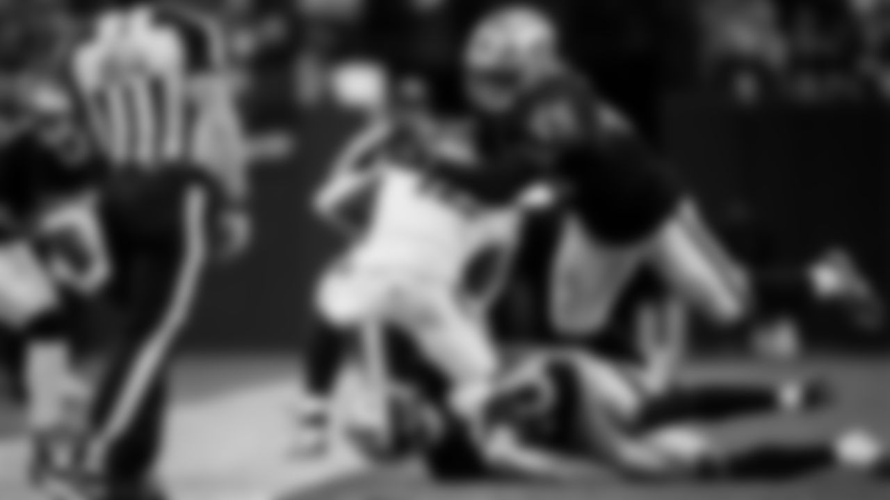 Las Vegas Raiders safety Isaiah Pola-Mao (20) and linebacker Devin White (45) make a tackle during the regular season home game against the Denver Broncos at Allegiant Stadium.