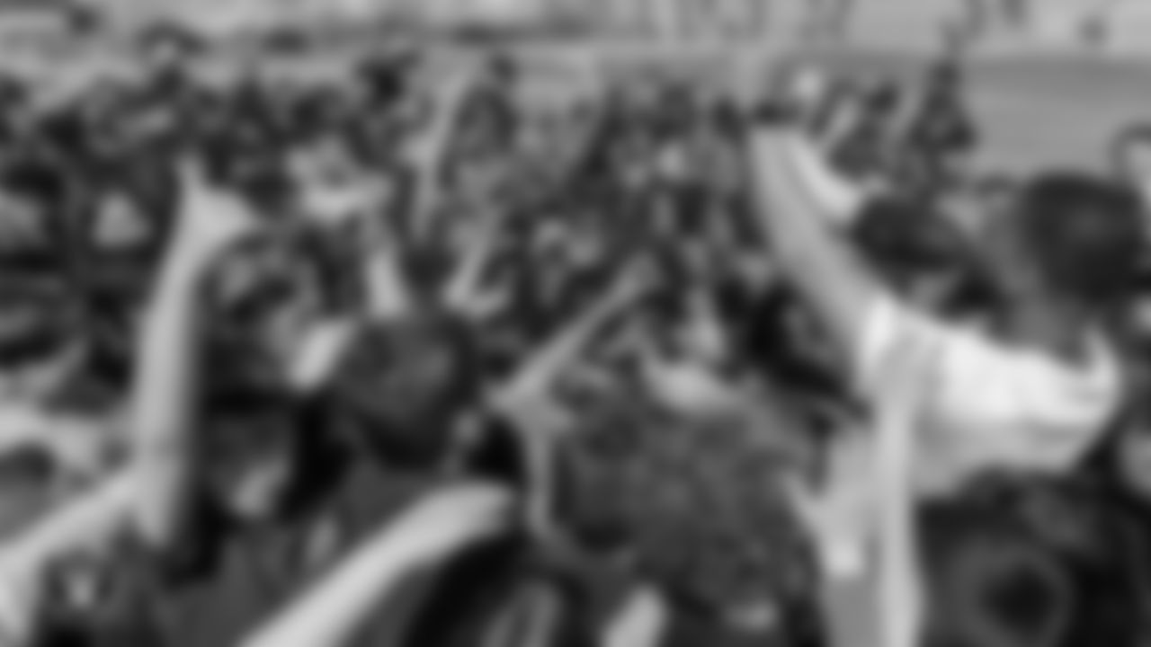 Las Vegas Raiders coordinator of football development Chris Shelby huddles with students during a Raiders Junior Training Camp at O.K. Adcock Elementary School.