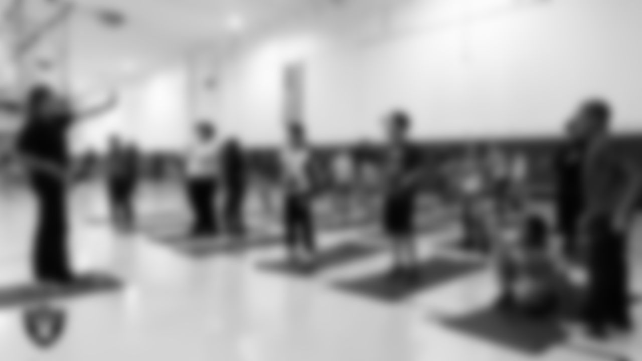 Youth community members practice yoga during the Las Vegas Raiders Stretch and Move program at Lied Memorial Clubhouse.