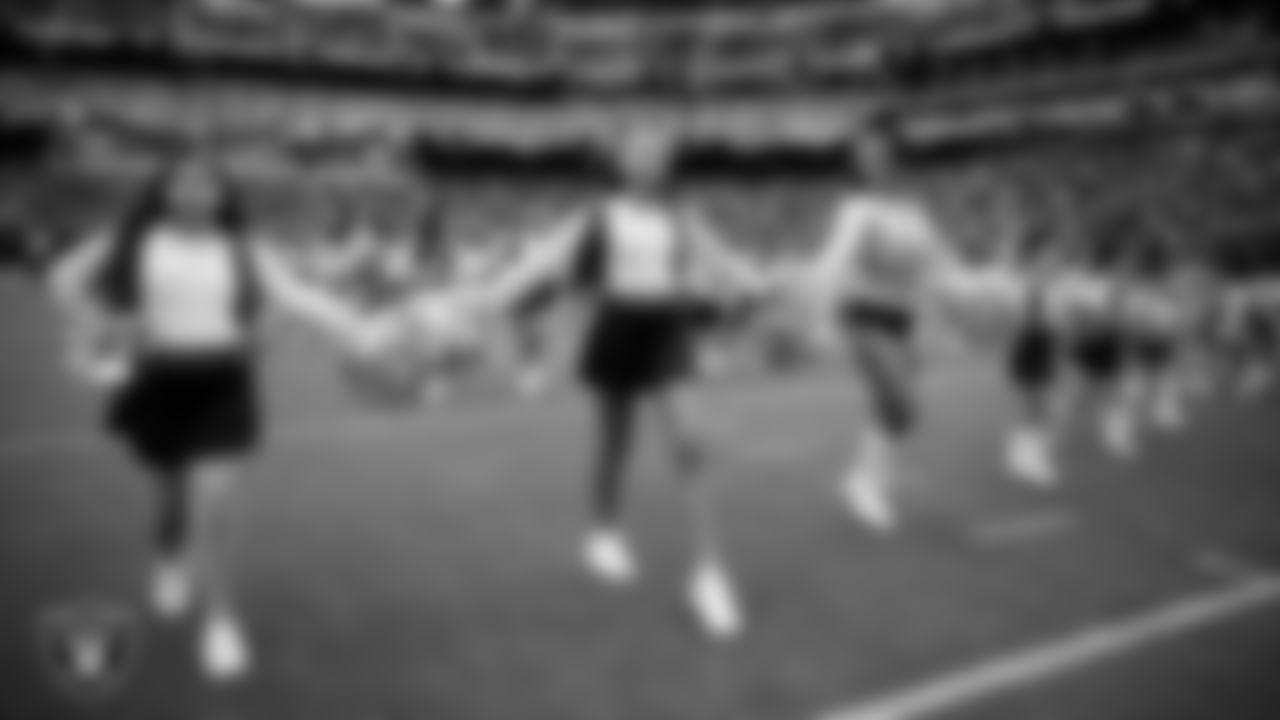 Raiderette Madisyn and Junior Raiderettes exit the field after their performance before the preseason home game against the San Francisco 49ers at Allegiant Stadium.