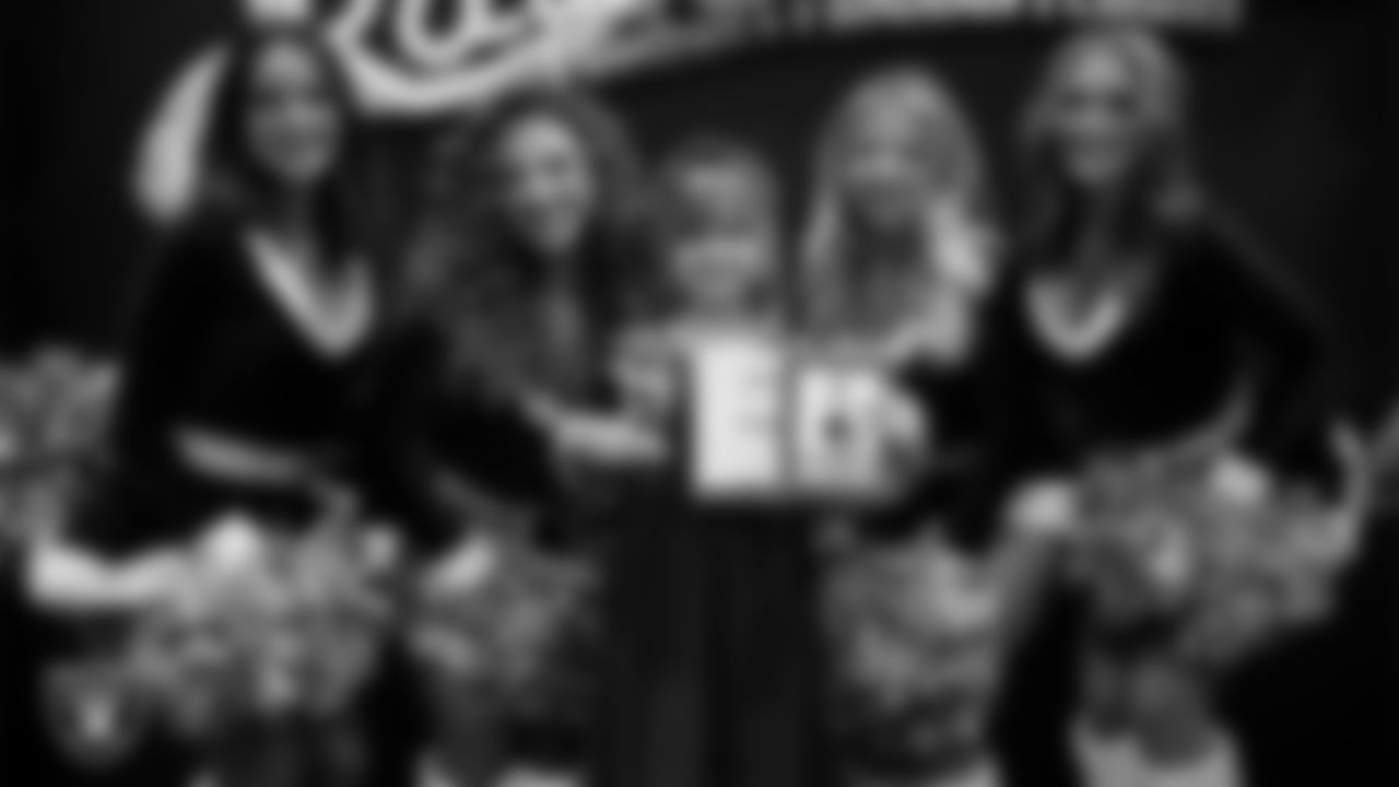 Raiderettes pose for a photo with a Junior Raiderette during the Junior Raiderettes Banquet at The Studio.