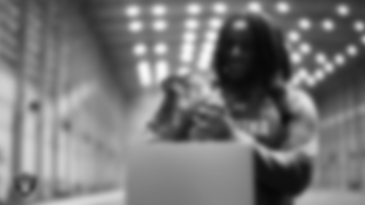 Las Vegas Raiders defensive tackle Tonka Hemingway (97) unboxes his custom cleats for the NFL's My Cause My Cleats initiative at Intermountain Health Performance Center.