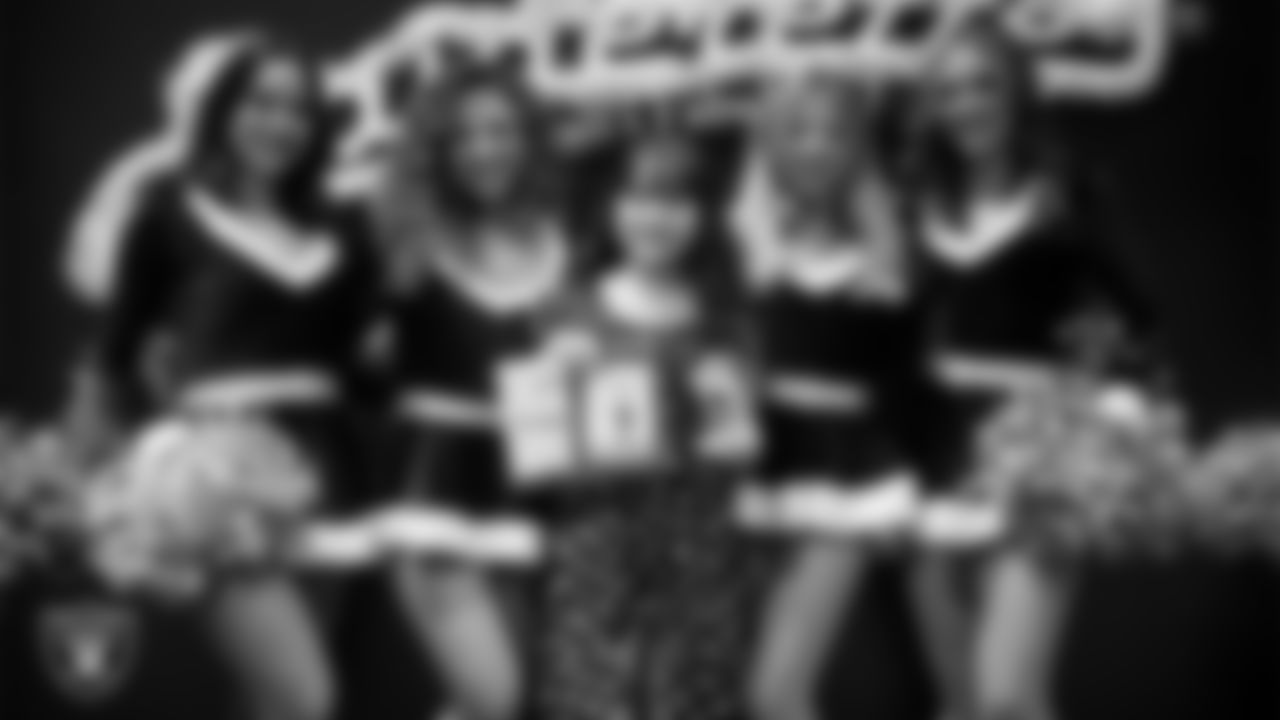 Raiderettes pose for a photo with a Junior Raiderette during the Junior Raiderettes Banquet at The Studio.