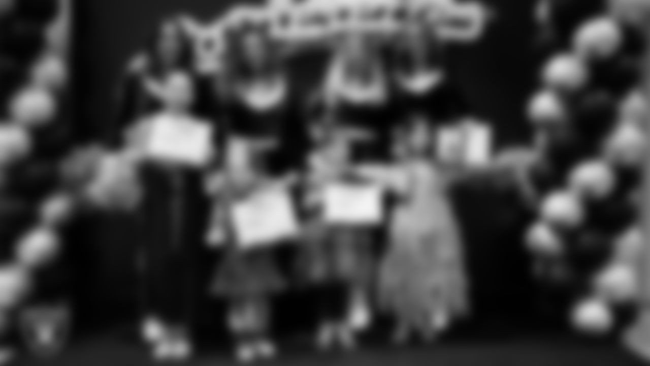 Raiderettes pose for a photo with Junior Raiderettes during the Junior Raiderettes Banquet at The Studio.