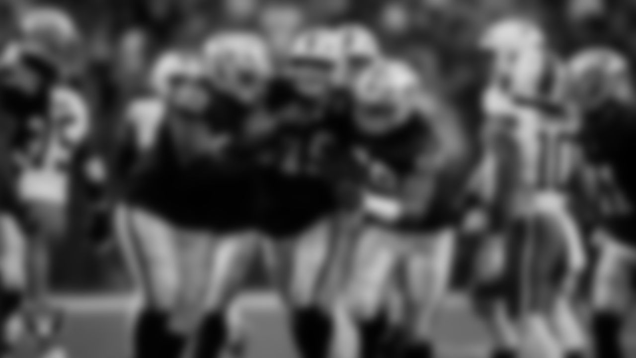 Las Vegas Raiders defensive end Charles Snowden (49) celebrates with teammates after making an interception during the regular season home game against the Cleveland Browns at Allegiant Stadium.