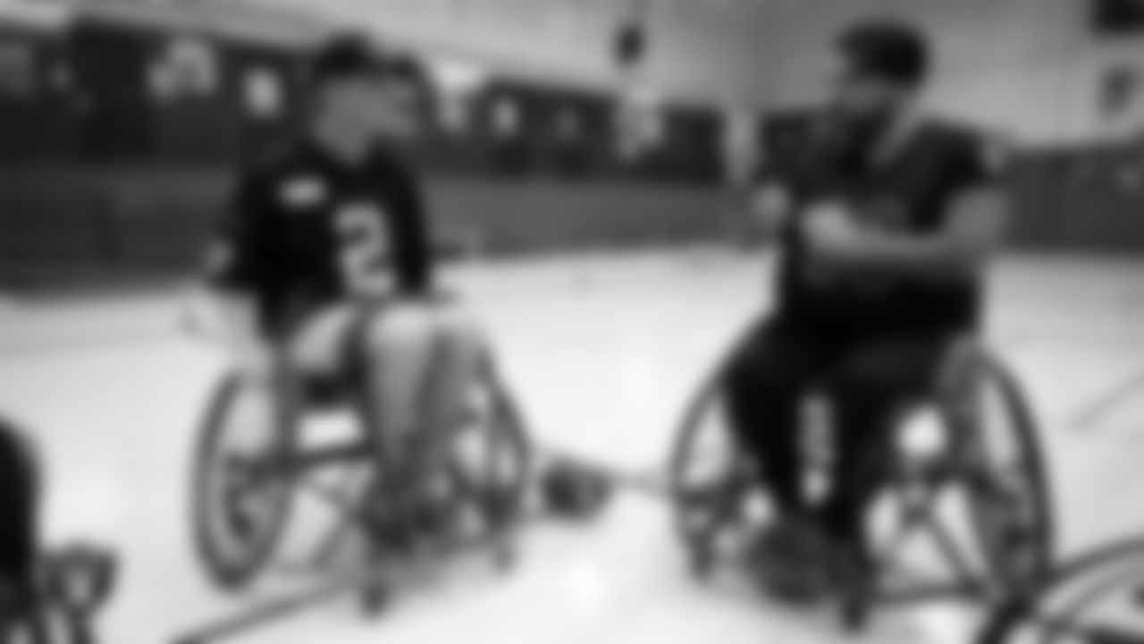 Las Vegas Raiders kicker Daniel Carlson (2) with a member of the City of Las Vegas Wheelchair Football League during practice at Dula Community Center.