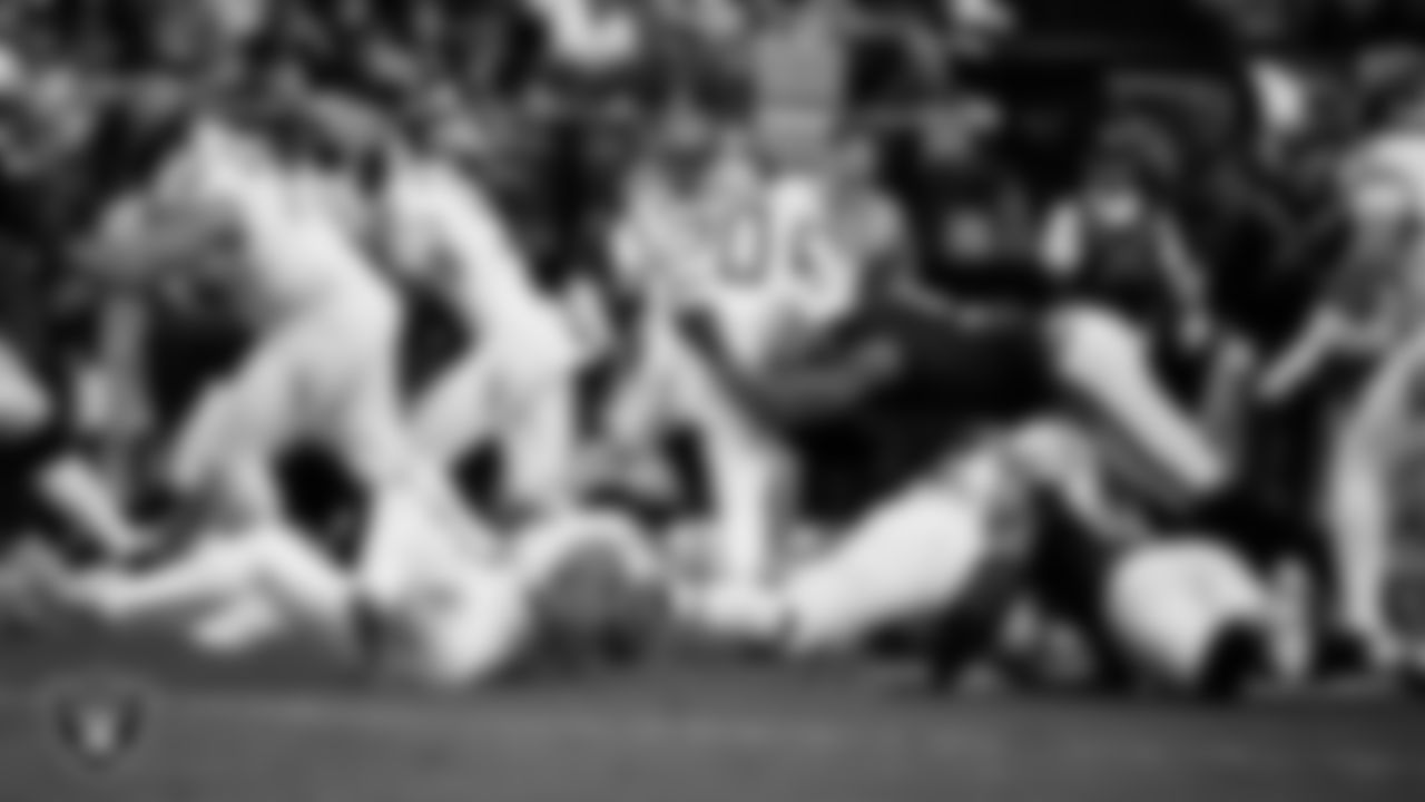Las Vegas Raiders defensive end Tyree Wilson (9) makes a tackle during the regular season home game against the Tennessee Titans at Allegiant Stadium.