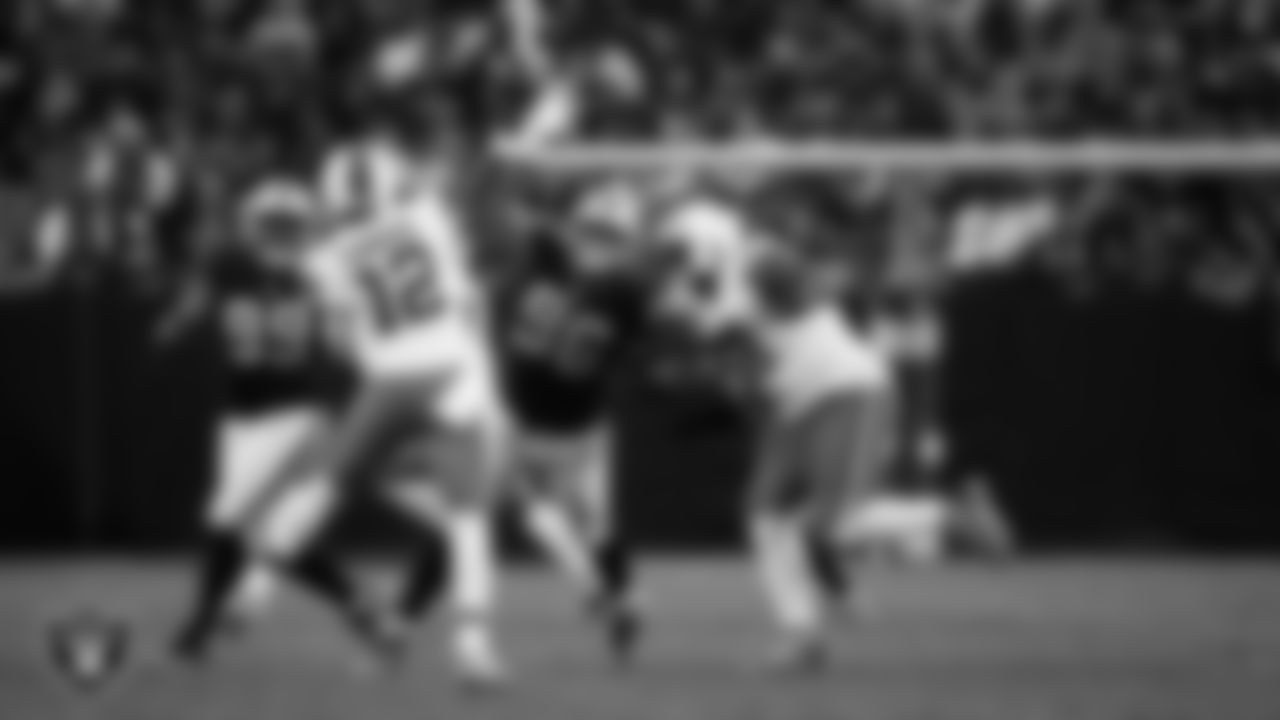 Las Vegas Raiders defensive tackle Thomas Booker IV (99) and defensive tackle Jonah Laulu (96) pressure the quarterback during the regular season home game against the Cleveland Browns at Allegiant Stadium.