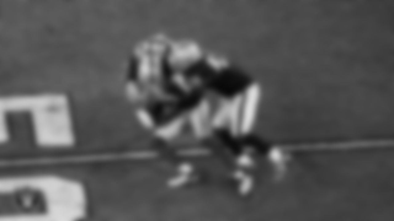 Las Vegas Raiders safety Isaiah Pola-Mao (20) and linebacker Devin White (45) make a tackle during the regular season home game against the Dallas Cowboys at Allegiant Stadium.