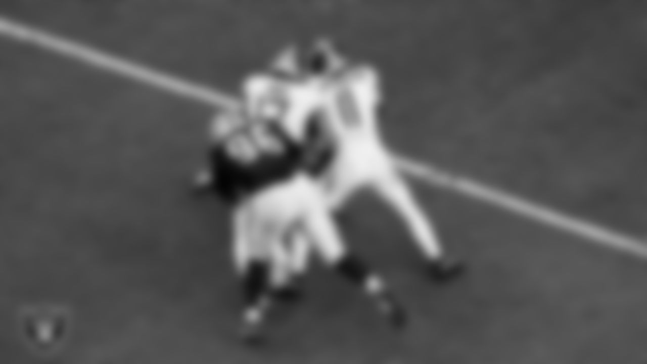 Las Vegas Raiders defensive tackle Jonah Laulu (96) makes a tackle during the regular season home game against the Tennessee Titans at Allegiant Stadium.