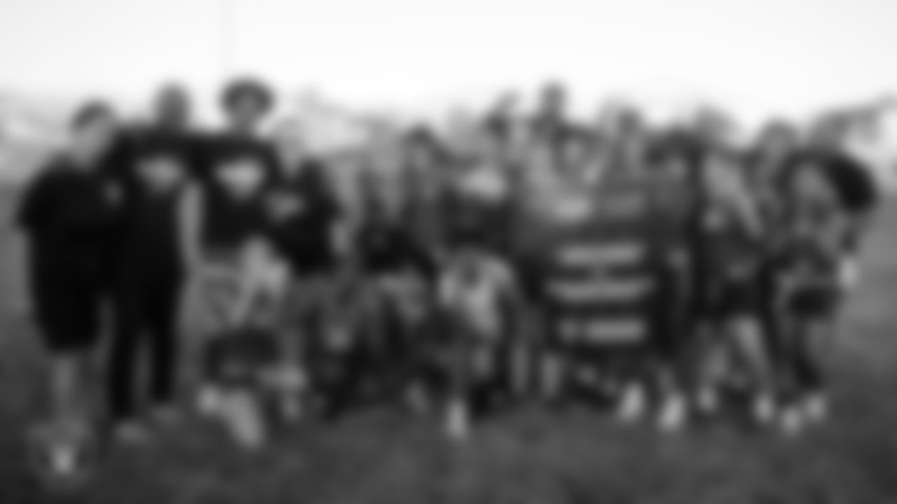 Las Vegas Raiders alumnus Korey Toomer poses for a photo with the Brian and Teri Cram Middle School flag football team after the Raiders' Middle School Flag Football Showcase game at Brian and Teri Cram Middle School.