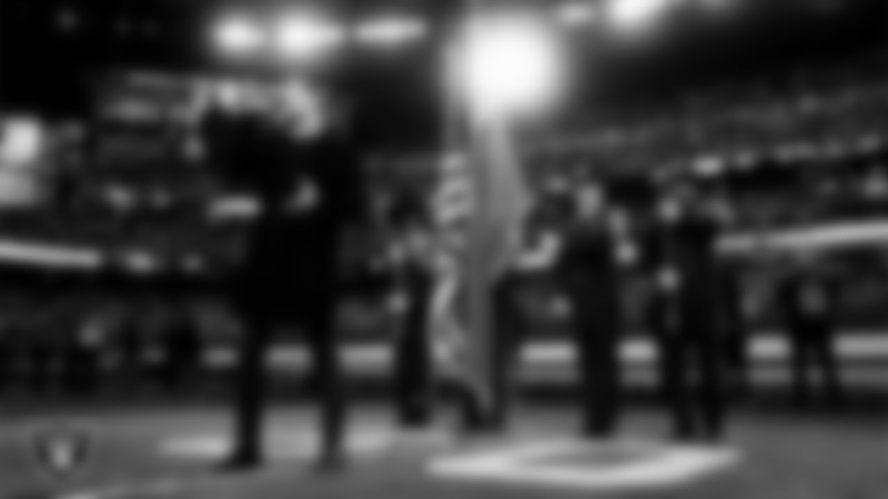 Singer Daniel Emmet performs the national anthem while the Henderson Fire Department Honor Guard presents the nation's colors before the Las Vegas Raiders' regular season home game against the Kansas City Chiefs at Allegiant Stadium.