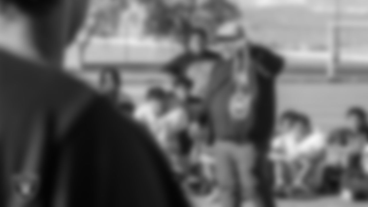 Las Vegas Raiders senior manager of football development Jordan Aguilar shows off the MVP chain to the Desert Oasis High School football team during practice at Desert Oasis High School.