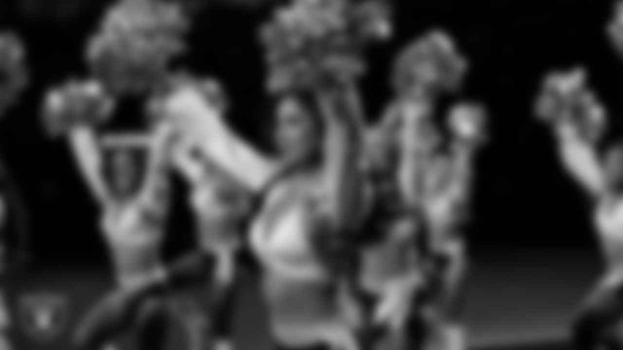 Raiderette Meekela walks onto the field for a performance during the regular season home game against the Dallas Cowboys at Allegiant Stadium.