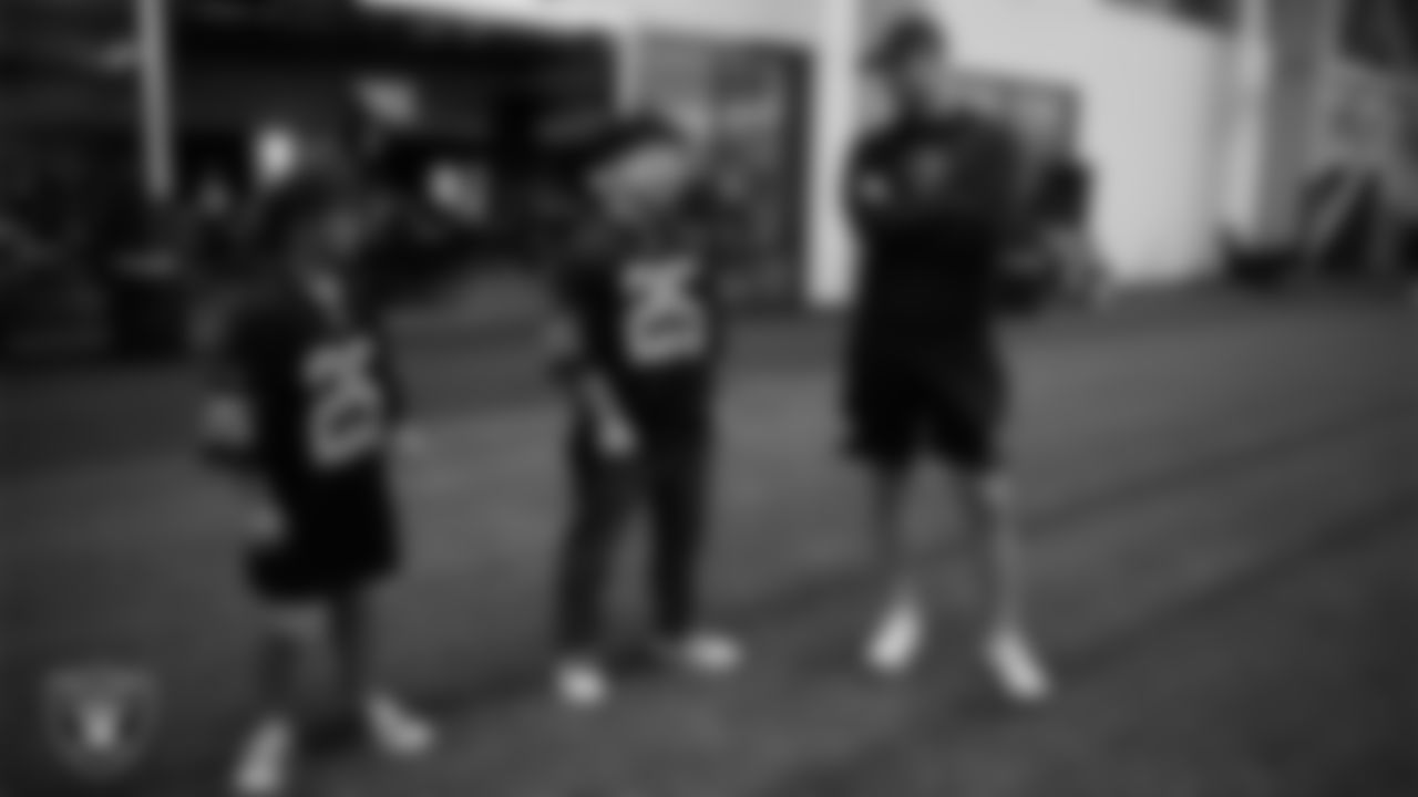 Christopher Arias and Marcos Carrillo from Make-A-Wish with Las Vegas Raiders General Manager John Spytek during a visit to Intermountain Health Performance Center.