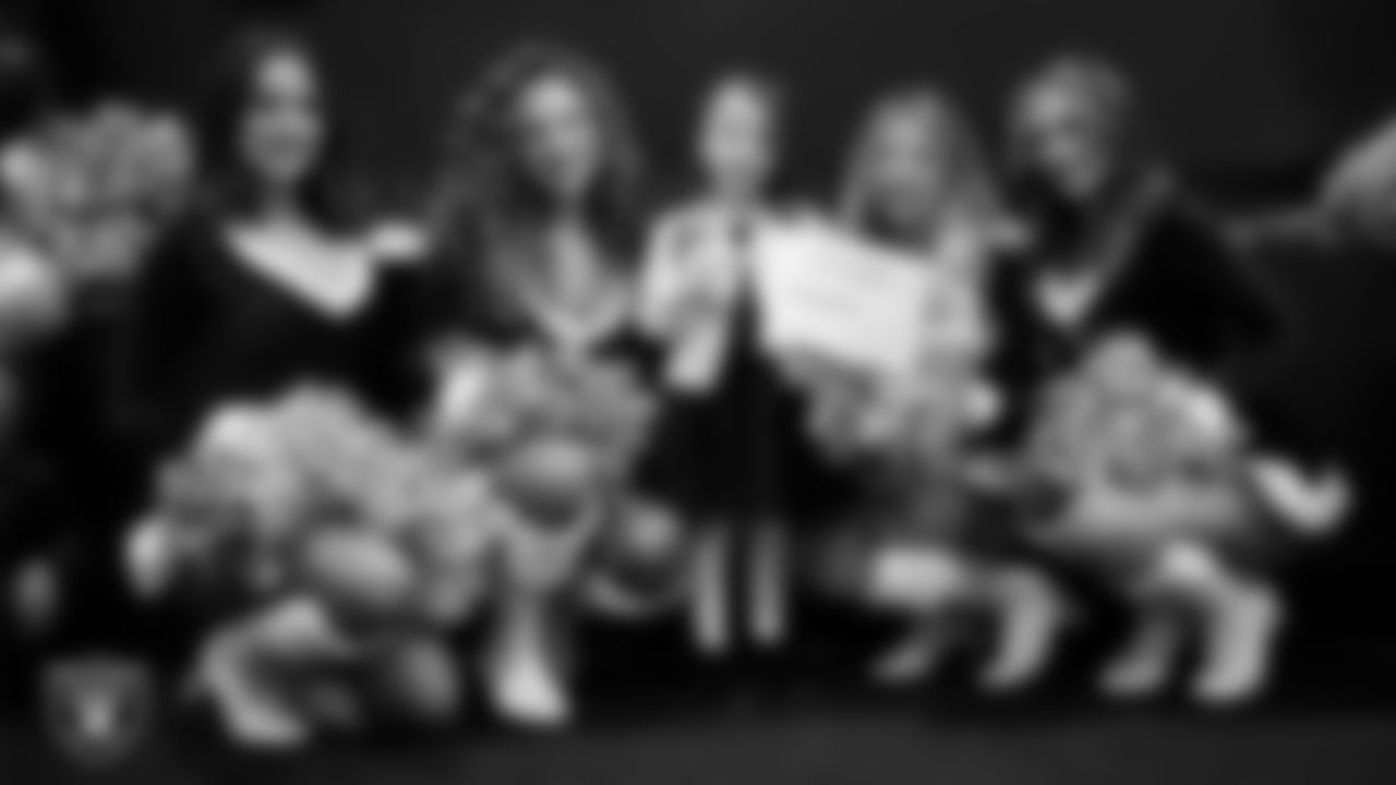 Raiderettes pose for a photo with a Junior Raiderette during the Junior Raiderettes Banquet at The Studio.