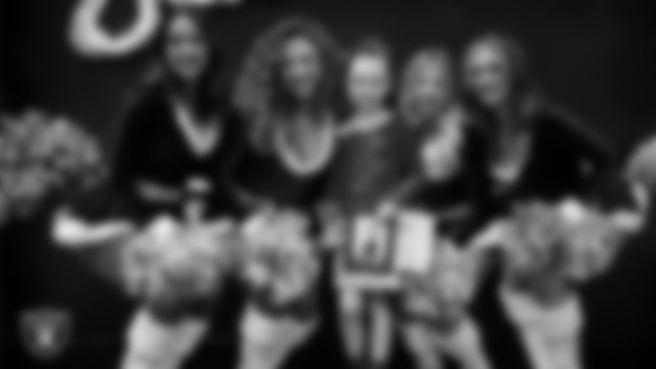 Raiderettes pose for a photo with a Junior Raiderette during the Junior Raiderettes Banquet at The Studio.