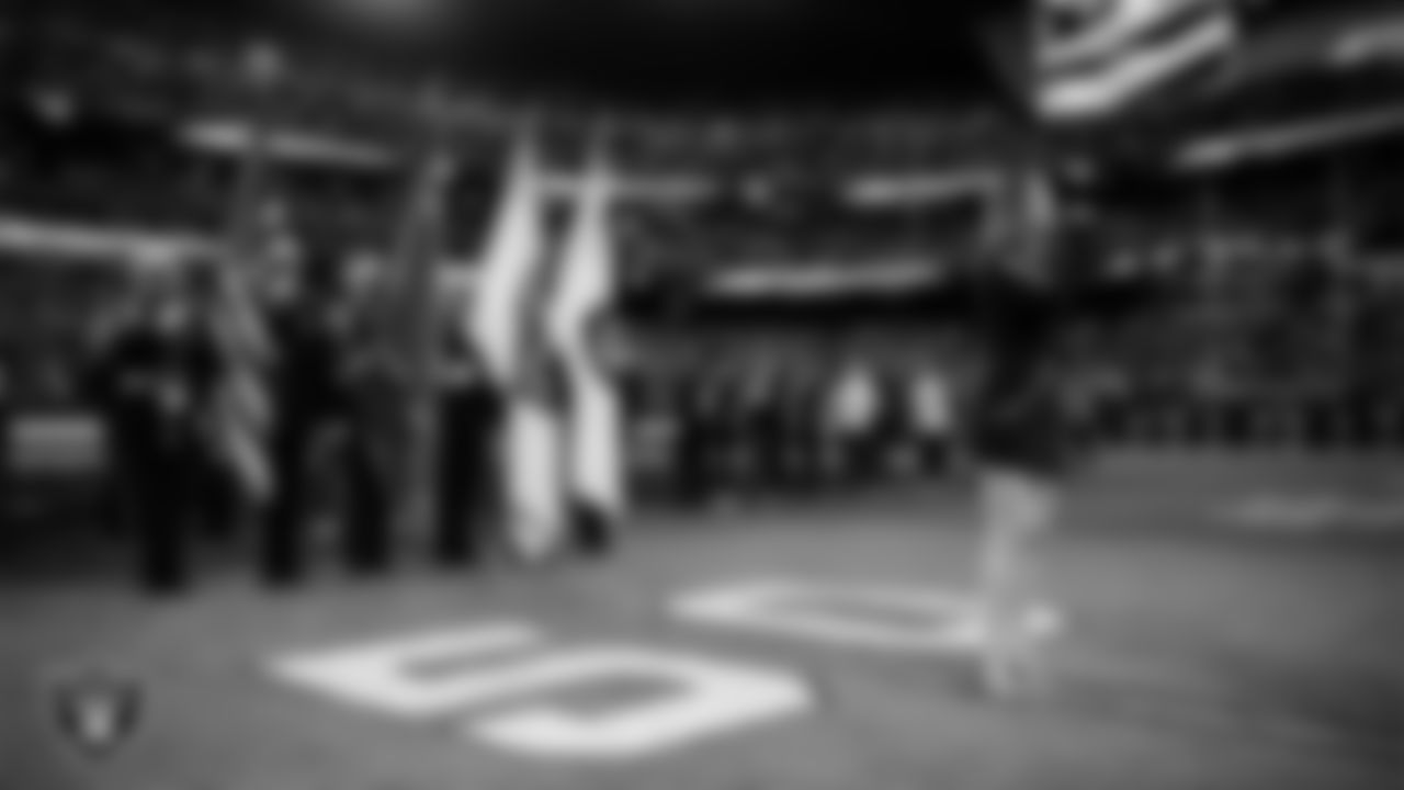 Singer Cassadee Pope performs the national anthem while the Clark County Fire Department Honor Guard presents the nation's colors before the Las Vegas Raiders' regular season home game against the Cleveland Browns at Allegiant Stadium.
