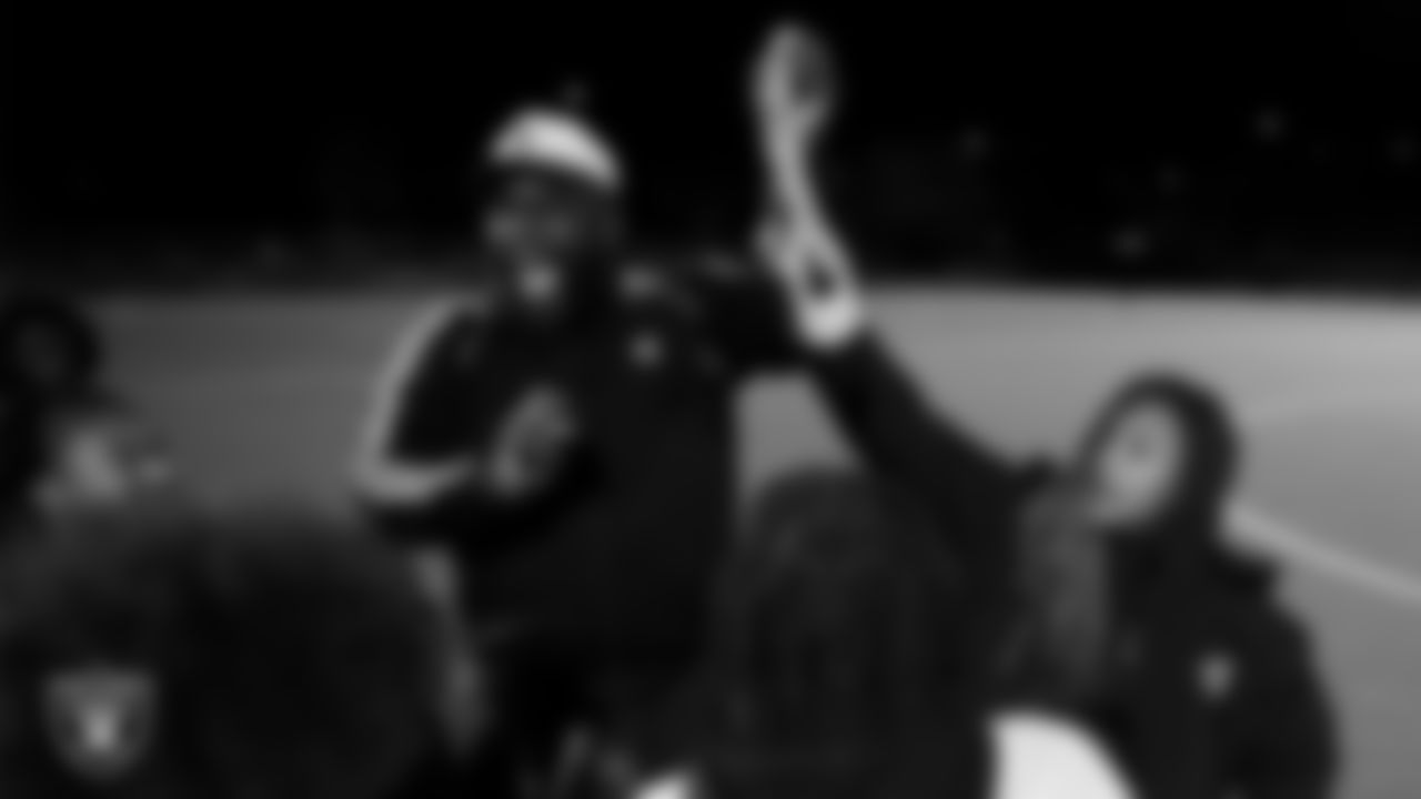 Las Vegas Raiders manager of football development Marli Bartlett presents the championship belt to the Democracy Preparatory Academy at Agassi Campus flag football team after the Raiders' High School Flag Football Showcase game at Doral Academy Red Rock.