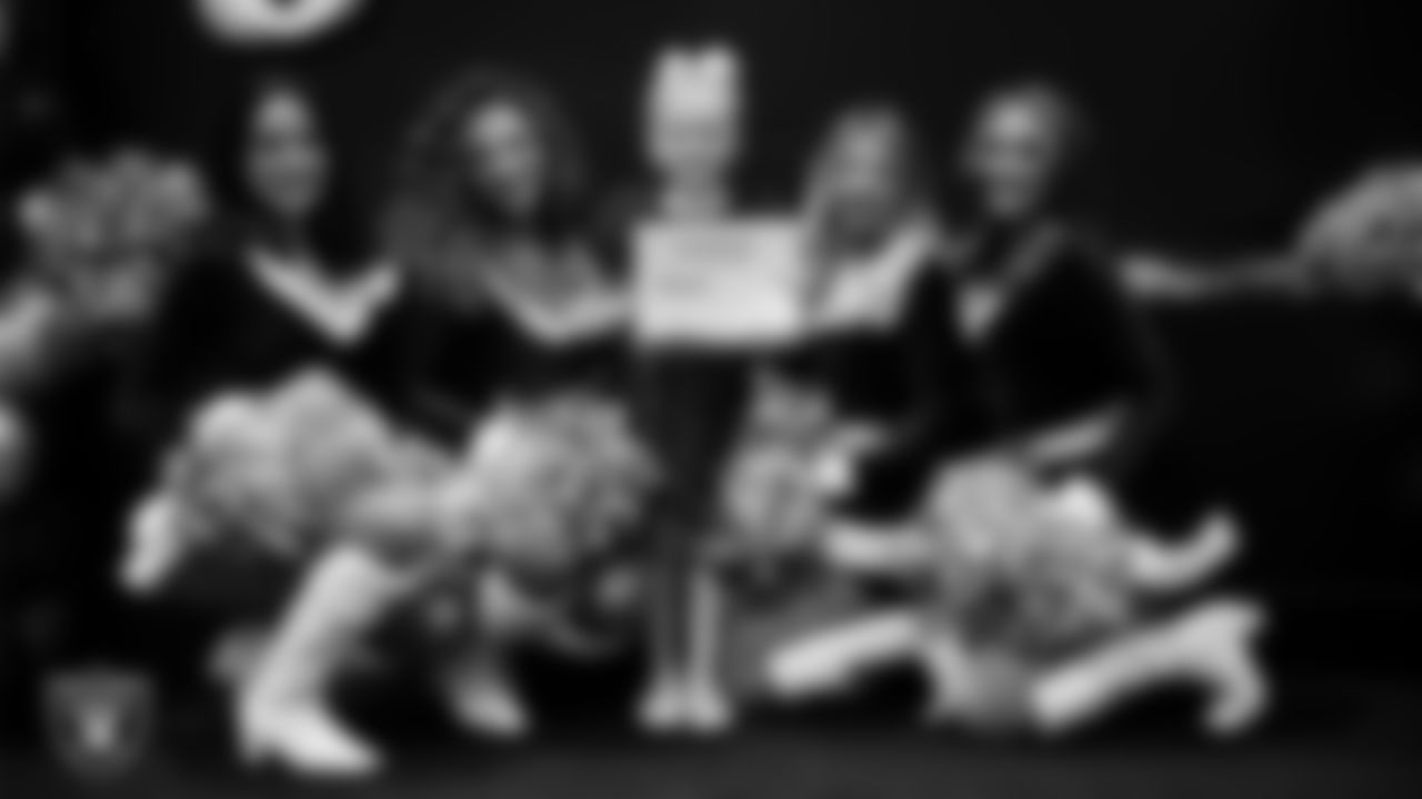 Raiderettes pose for a photo with a Junior Raiderette during the Junior Raiderettes Banquet at The Studio.