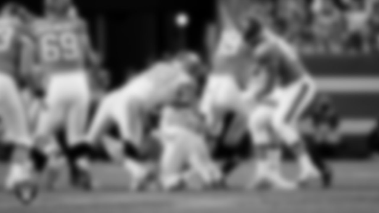 Las Vegas Raiders defensive end Maxx Crosby (98) and linebacker Elandon Roberts (52) during the regular season away game against the Denver Broncos at Empower Field at Mile High.