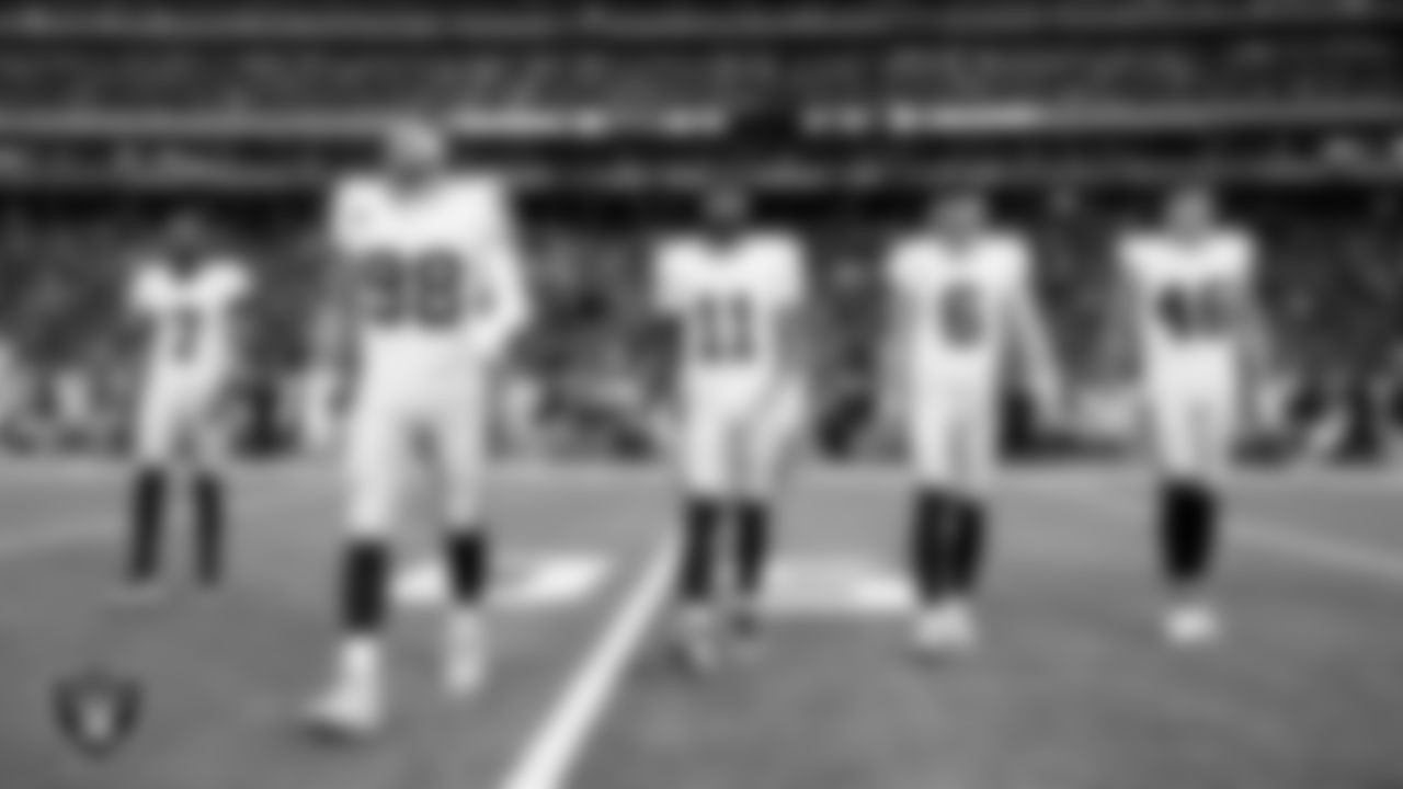 The Las Vegas Raiders walk out to the center of the field for the coin toss before the regular season away game against the the Houston Texans at NRG Stadium.