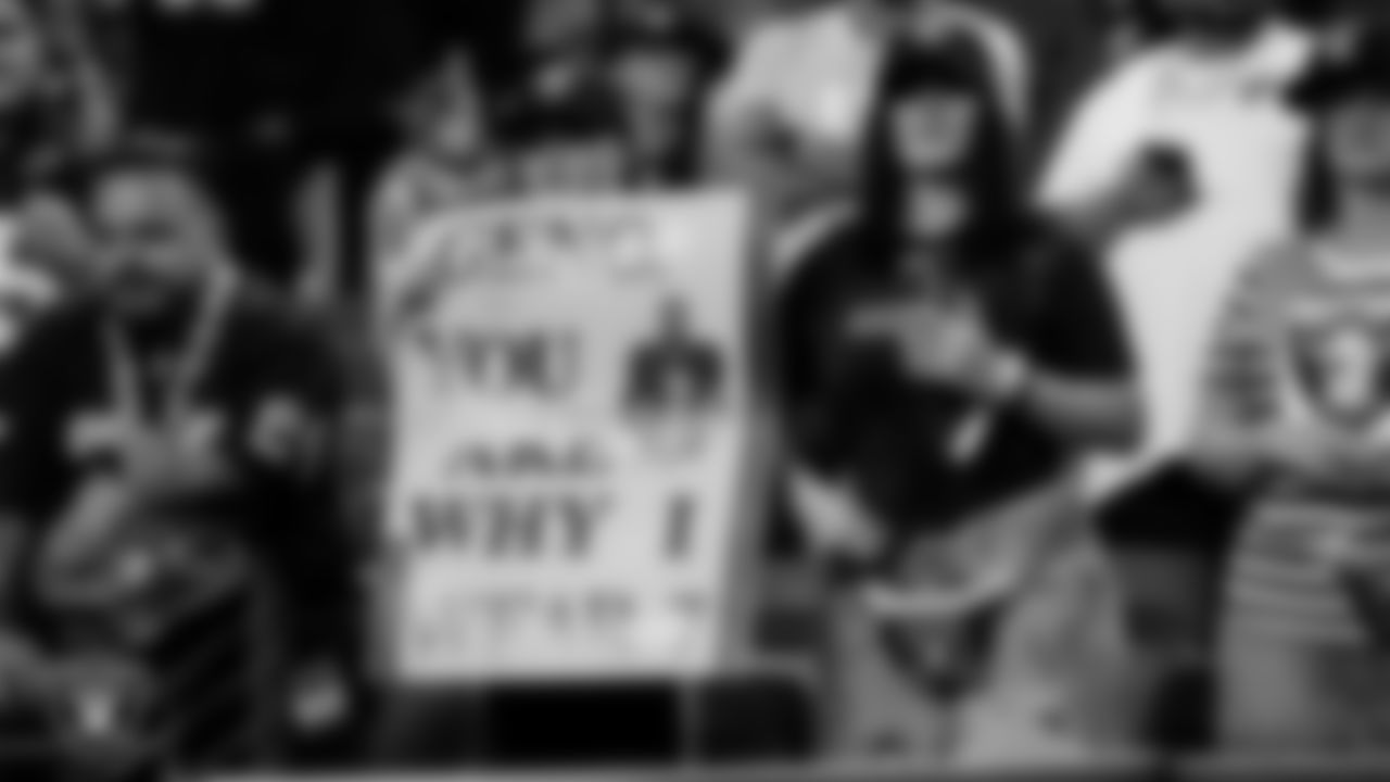 Las Vegas Raiders fans with signs before the regular season home game against the Los Angeles Chargers at Allegiant Stadium.