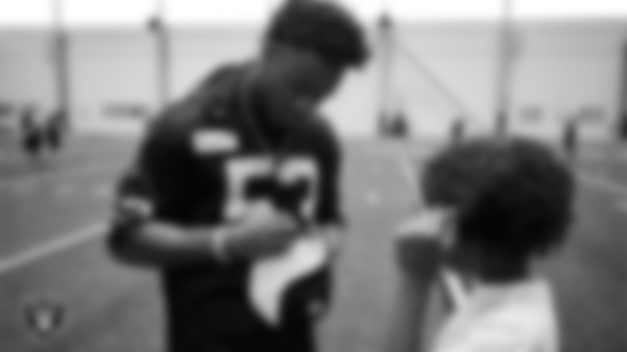 Las Vegas Raiders linebacker Amari Gainer (53) signs an autograph at a skills camp during Play Football Day at Intermountain Health Performance Center.