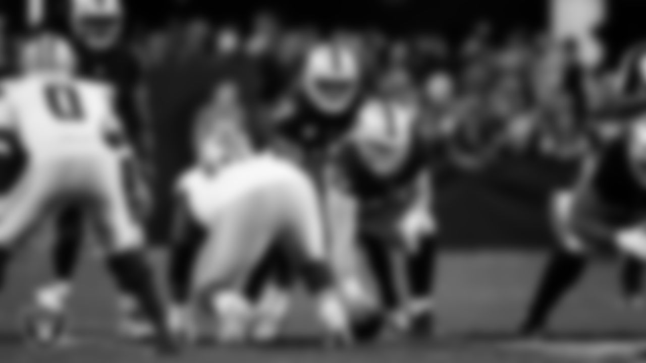 Las Vegas Raiders quarterback Geno Smith (7) and center Will Putnam (67) line up before the snap during the regular season home game against the Dallas Cowboys at Allegiant Stadium.