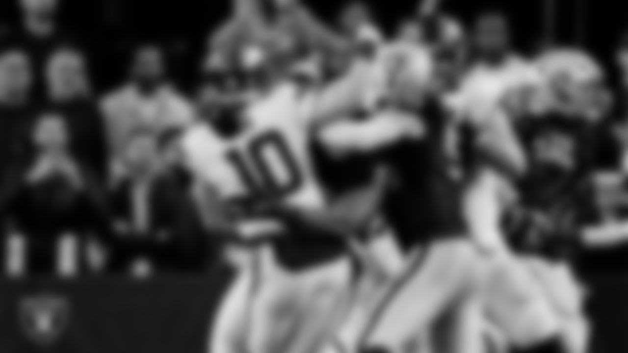 Las Vegas Raiders defensive tackle Thomas Booker IV (99) and defensive end Maxx Crosby (98) pressure the quarterback during the regular season home game against the Denver Broncos at Allegiant Stadium.