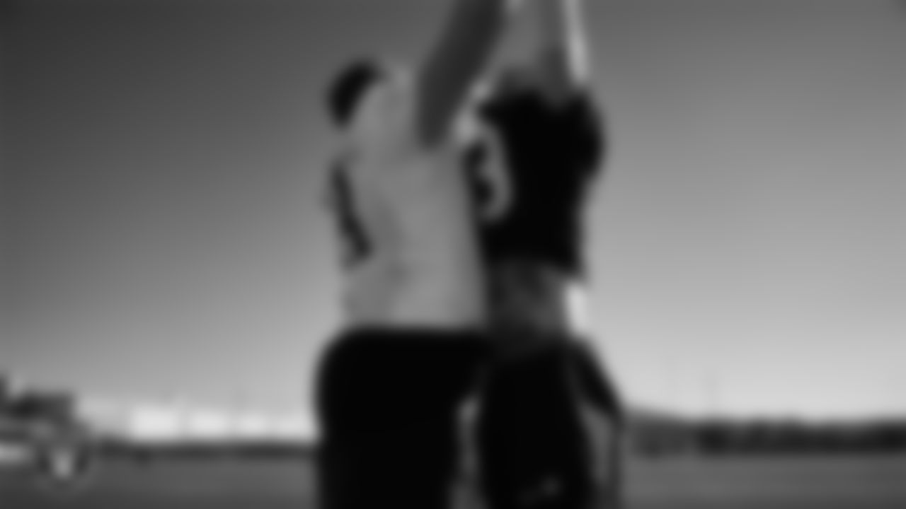 Las Vegas Raiders guard/center Jackson Powers-Johnson (58) and defensive end Maxx Crosby (98) during practice at Intermountain Health Performance Center.