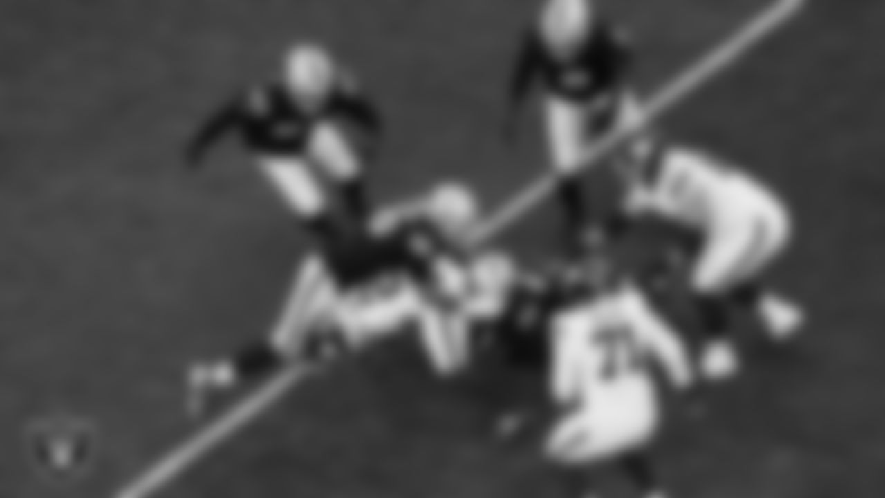 Las Vegas Raiders defensive tackle Jonah Laulu (96) and linebacker Devin White (45) make a tackle during the regular season home game against the New York Giants at Allegiant Stadium.