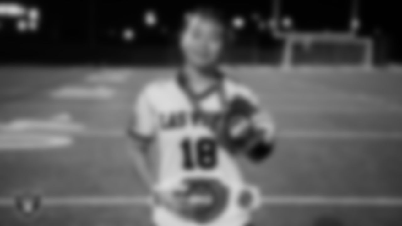 Las Vegas High School wide receiver/linebacker/defensive back Lissette Do (18) poses for a photo with the MVP chain after winning the Las Vegas Raiders' High School Flag Football Showcase game at Mater East Academy.