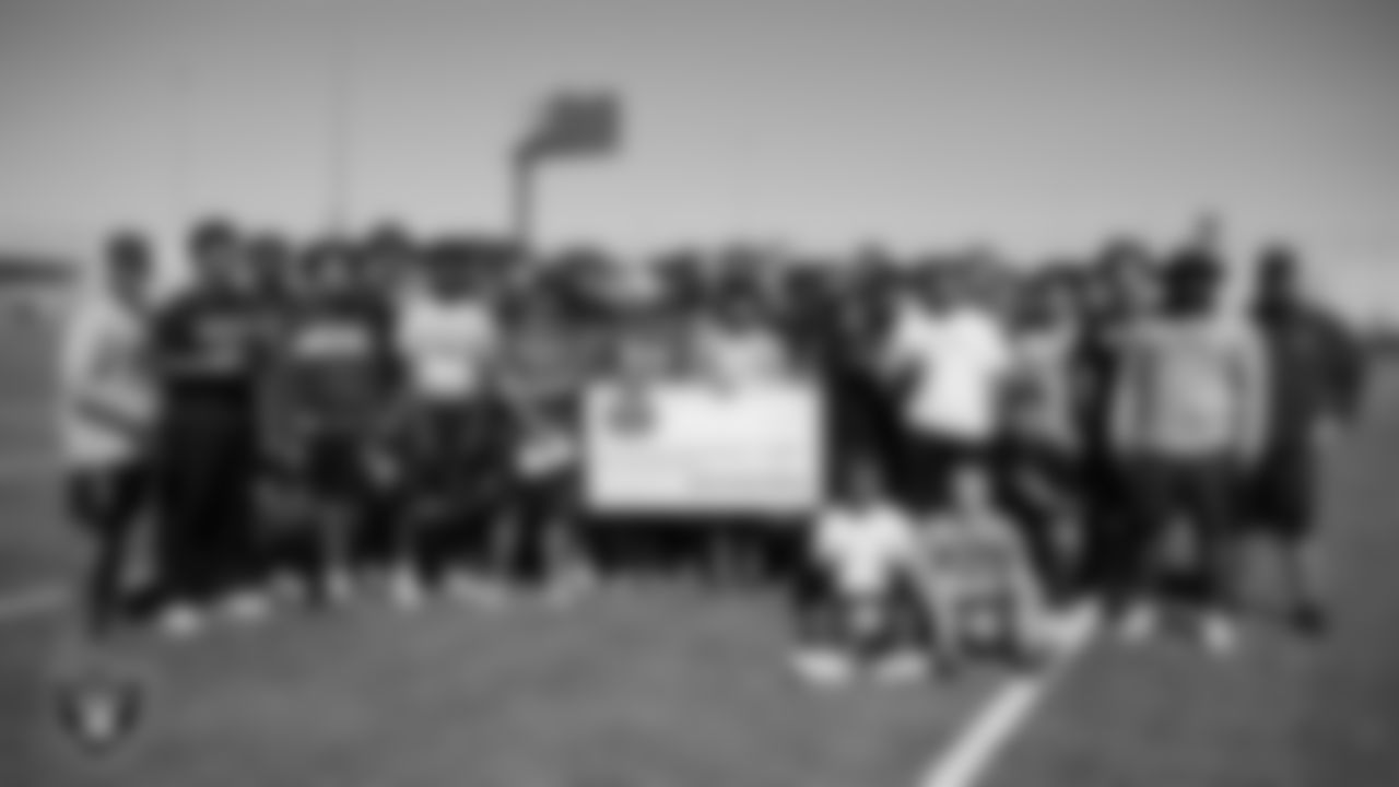 Silverado High School football coach Tony Barilla poses for a photo with his team during practice at Silverado High School.
