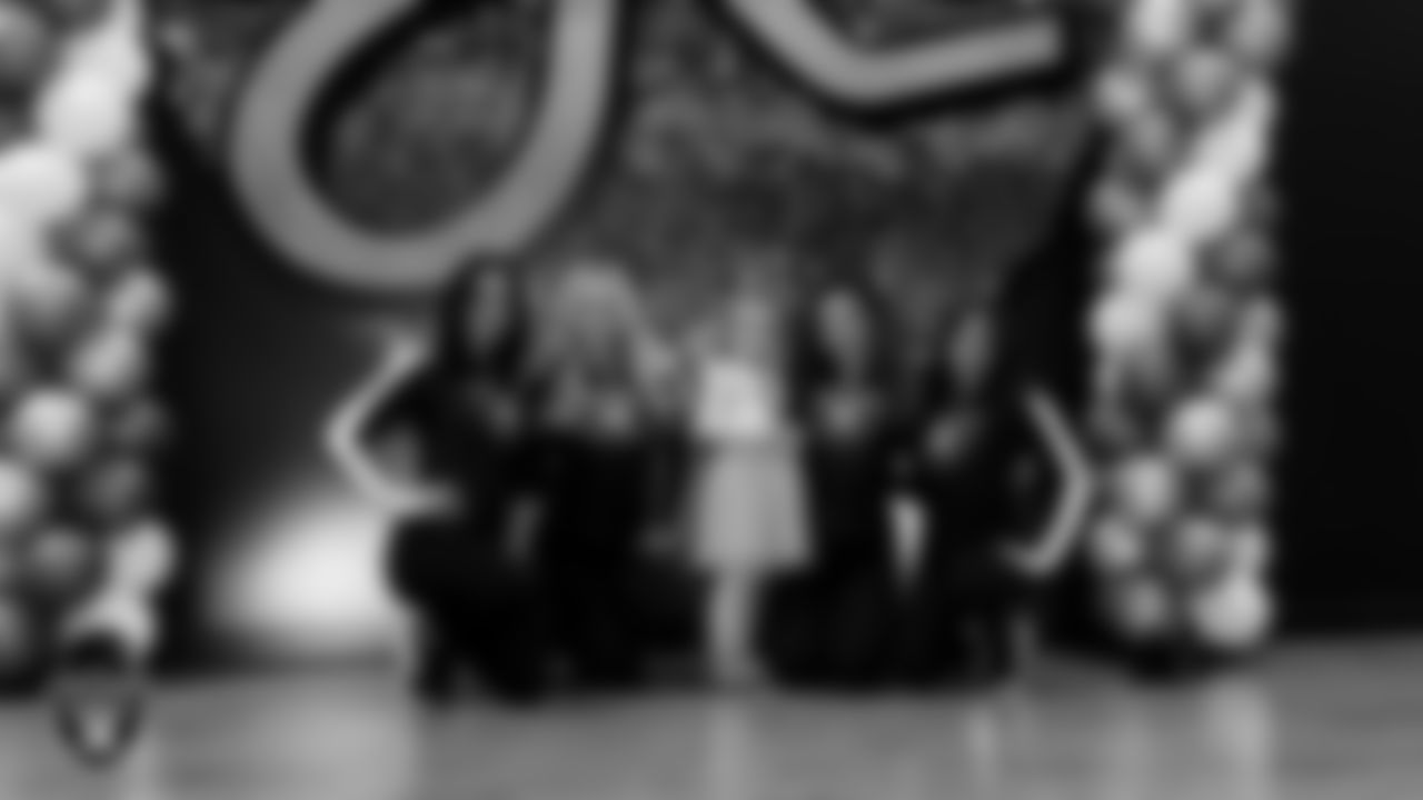 Raiderettes Reagan, Delaney, Lexie and Ashtin pose for a photo with an attendee during the Valentine's Day Dance at The Studio.