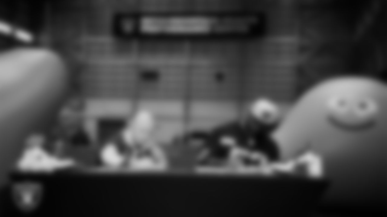 Las Vegas Raiders linebacker Elandon Roberts (52) designs cleats for My Cause My Cleats with Intermountain Children's Health patient Isaak at Intermountain Health Performance Center.