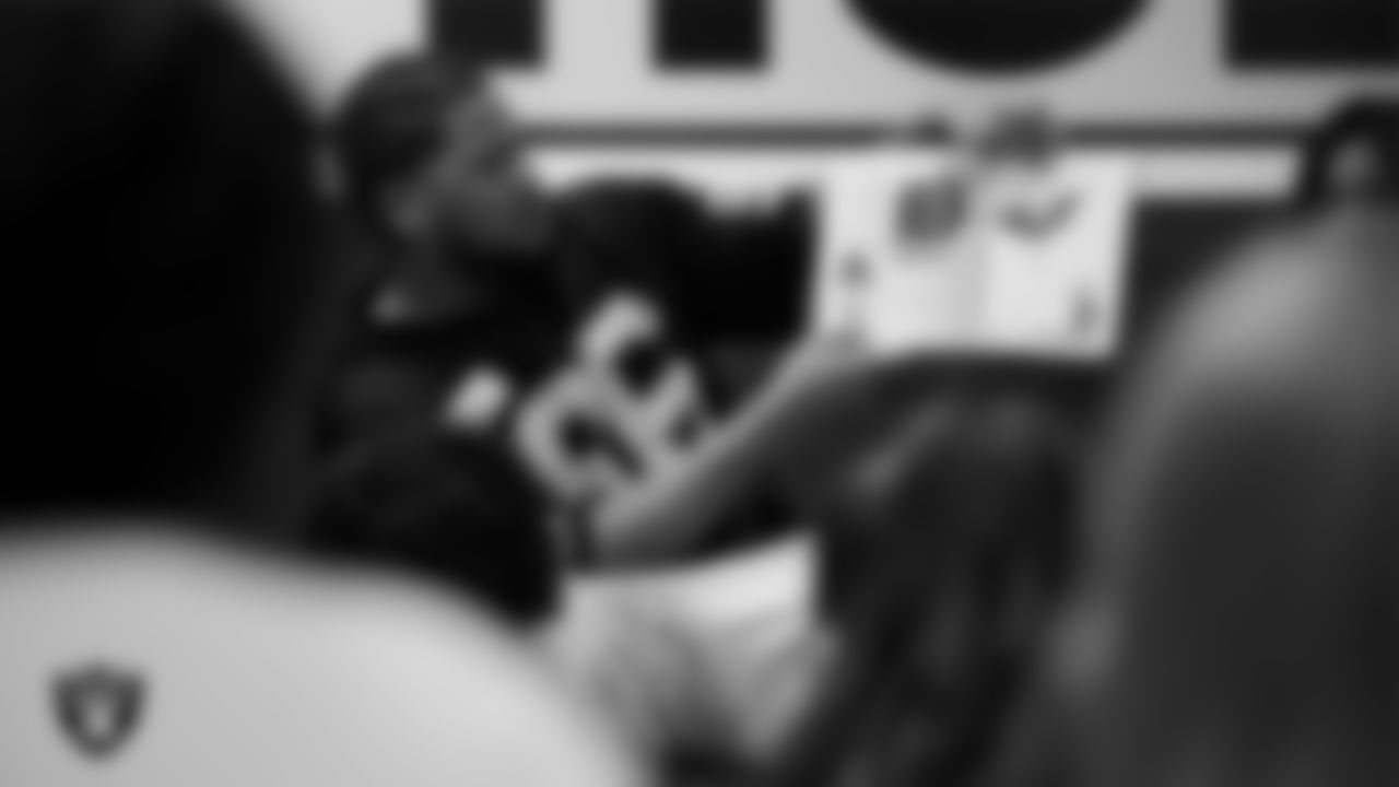 Las Vegas Raiders defensive tackle Jonah Laulu (96) reads to students during Nevada Reading Week at Robert Taylor Elementary School.